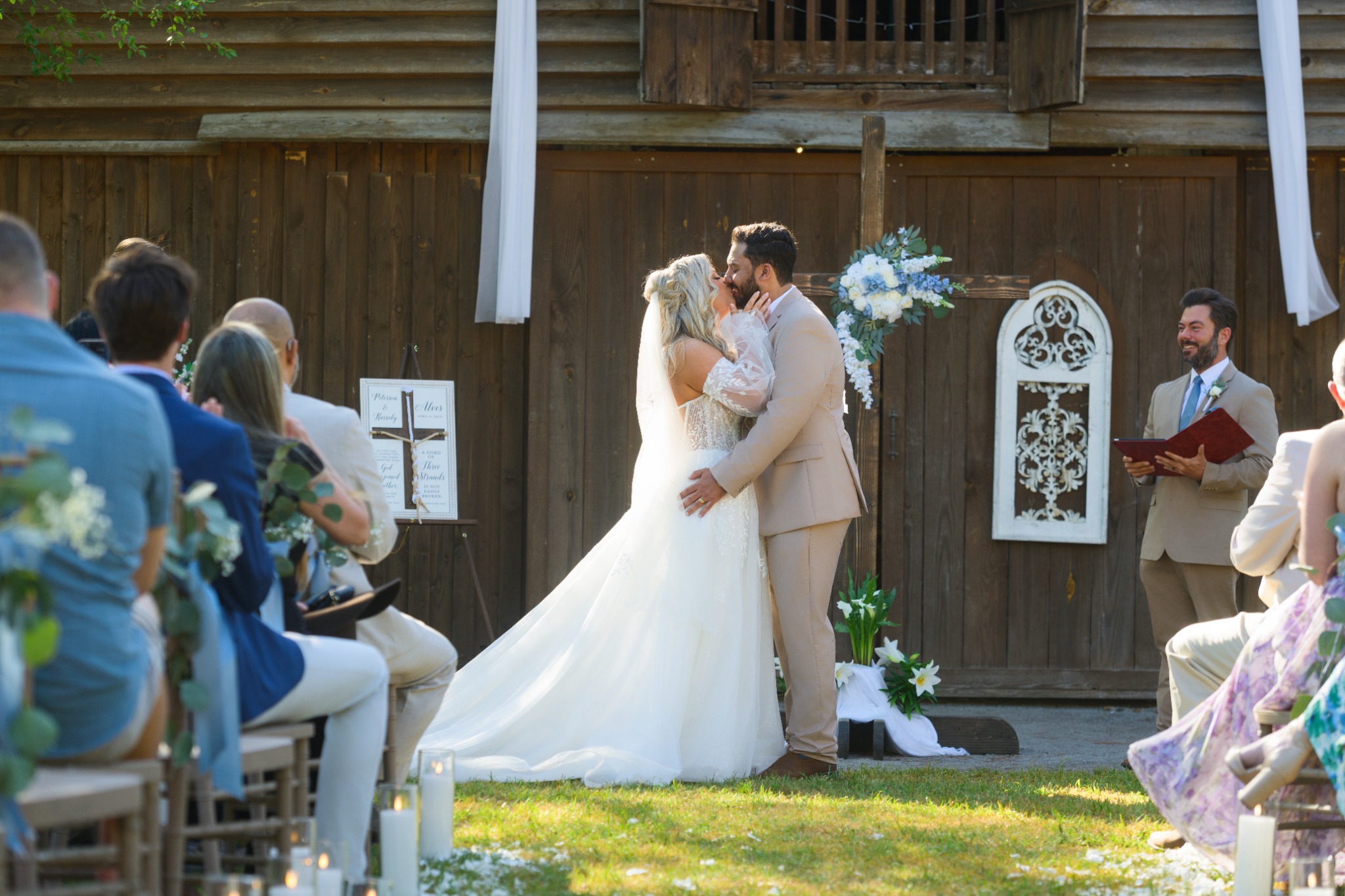 Newlyweds sharing their first kiss during their ceremony at Wildhorse at Parker Farms